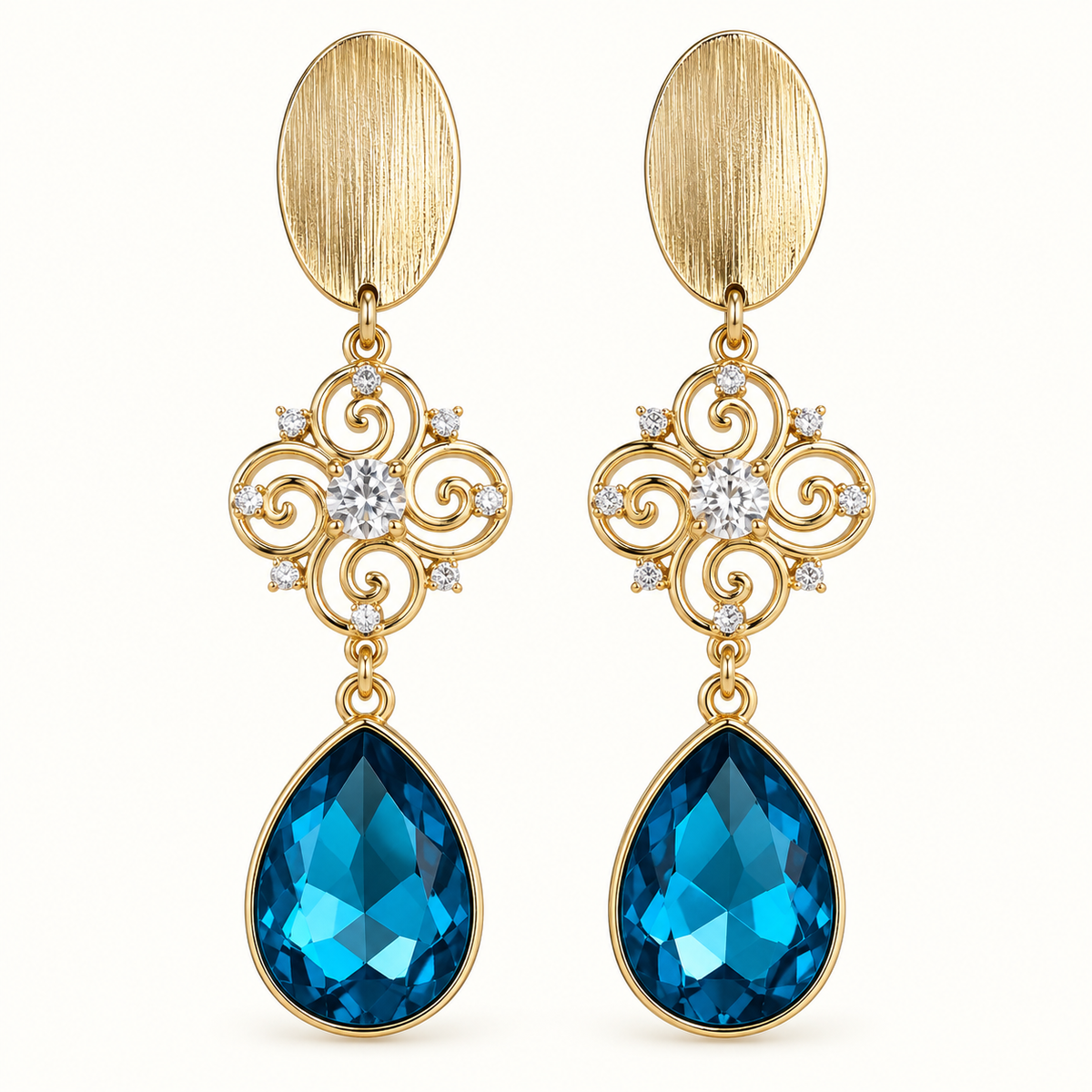 Aros Azul Imperial dorados con cristal azul en forma de gota y detalles de circones