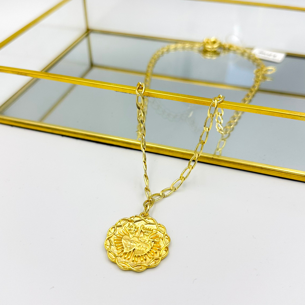 Detalle medallón Sagrado Corazón dorado con relieve ornamental MCJoyas